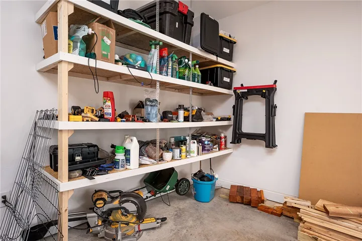 Functional garage features organized shelving and a concrete floor, perfect for storage and projects.