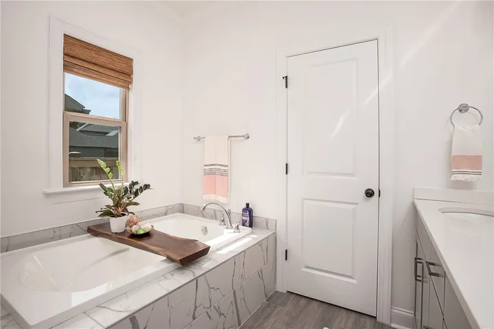Luxurious soaking tub and sleek vanity offer a tranquil retreat.
