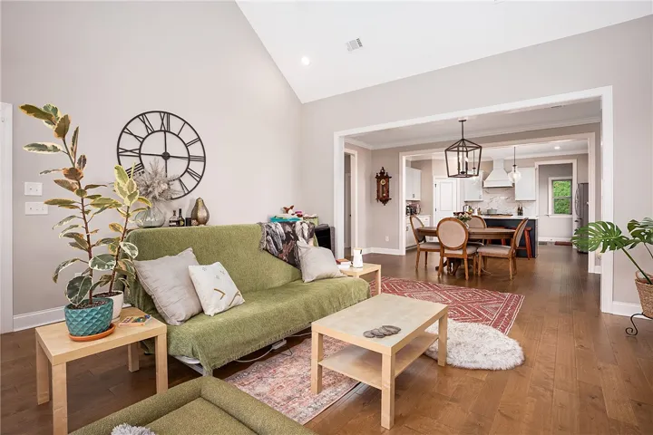 Hardwood floors and soaring vaulted ceilings define this inviting open-concept living space.