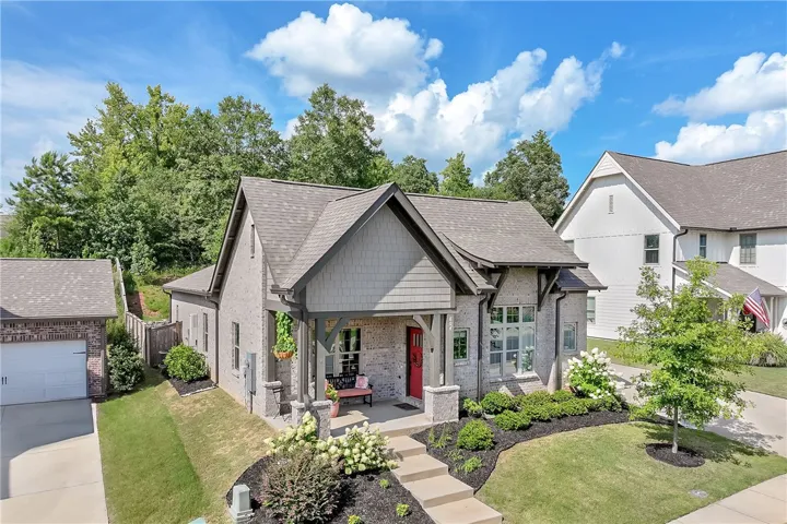 A charming exterior, boasting a welcoming front porch, offers curb appeal and a detached garage.
