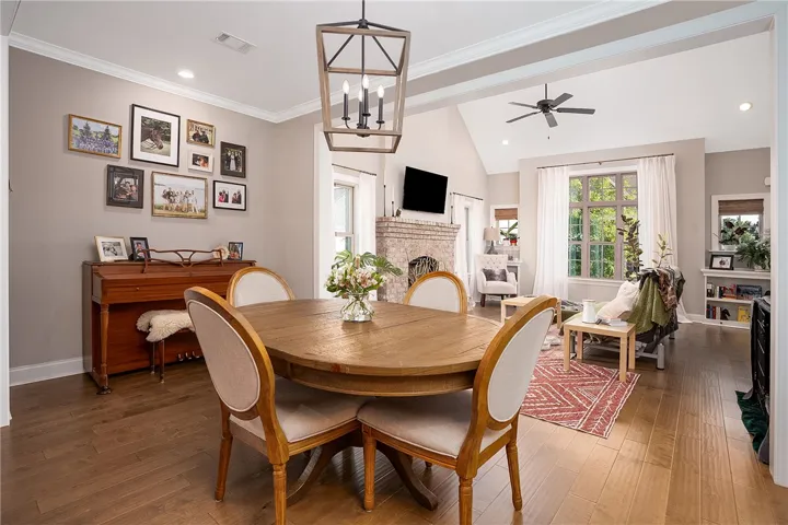 Hardwood floors and vaulted ceilings create an inviting and open concept living and dining area.