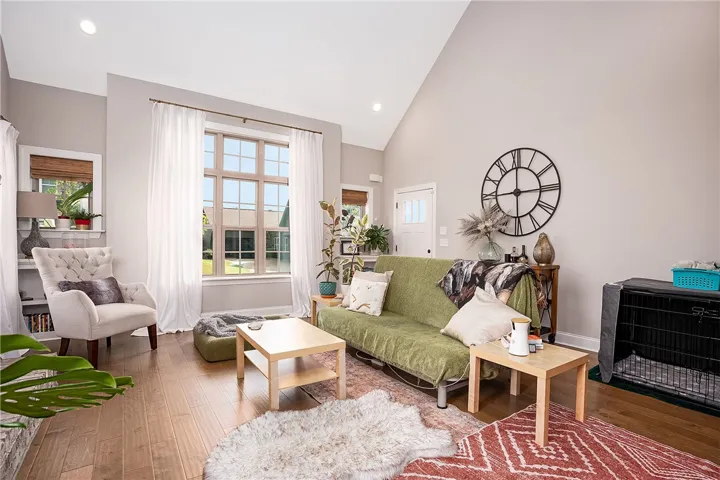 An inviting living area with a dramatic vaulted ceiling and generous windows.