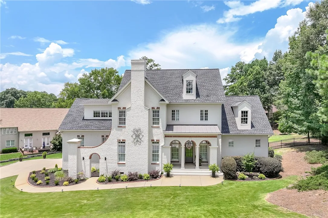 Grand brick facade with archways welcomes guests to this distinguished residence.