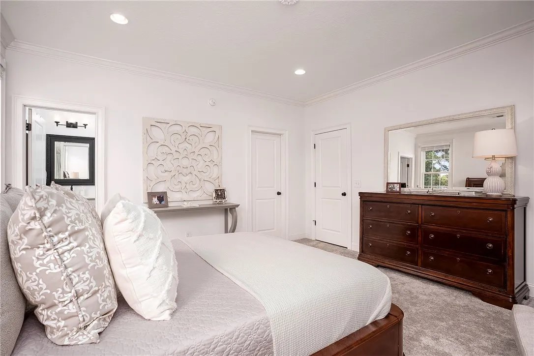 Crisp white walls and plush carpeting create a tranquil retreat in this inviting private space.