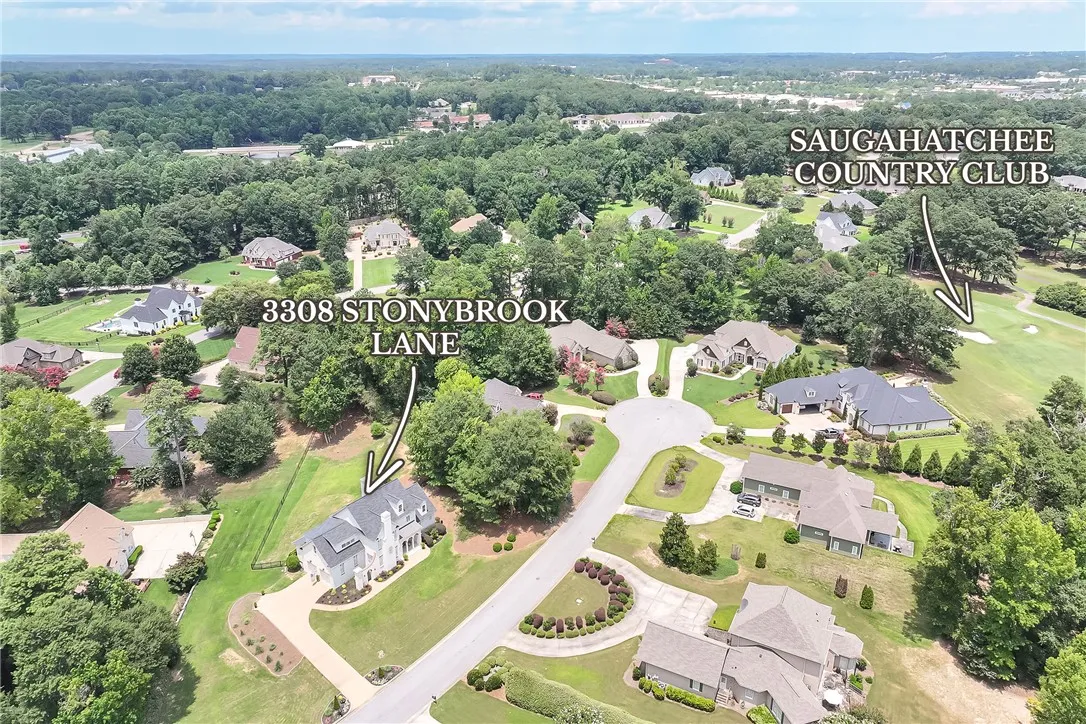 An aerial perspective reveals a prime residence nestled within a verdant, well-established neighborhood.