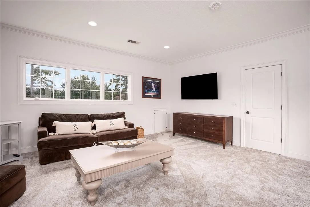Recessed lighting illuminates this inviting living space, creating a cozy ambiance perfect for relaxation.