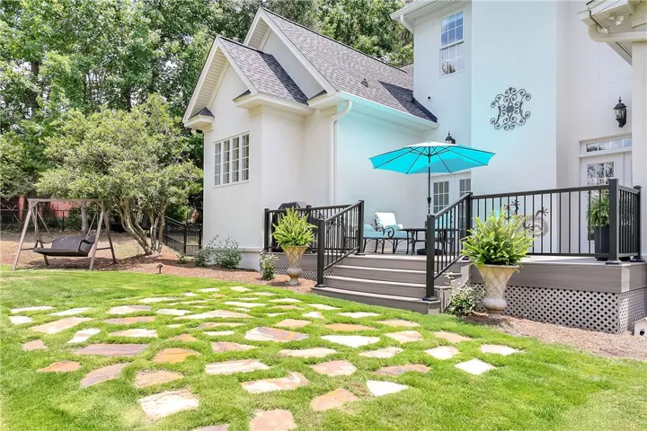 A tranquil backyard oasis with a raised deck, perfect for relaxation and outdoor entertaining.