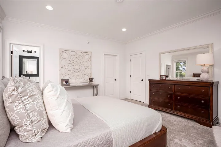 Crisp white walls and plush carpeting create a tranquil retreat in this inviting private space.