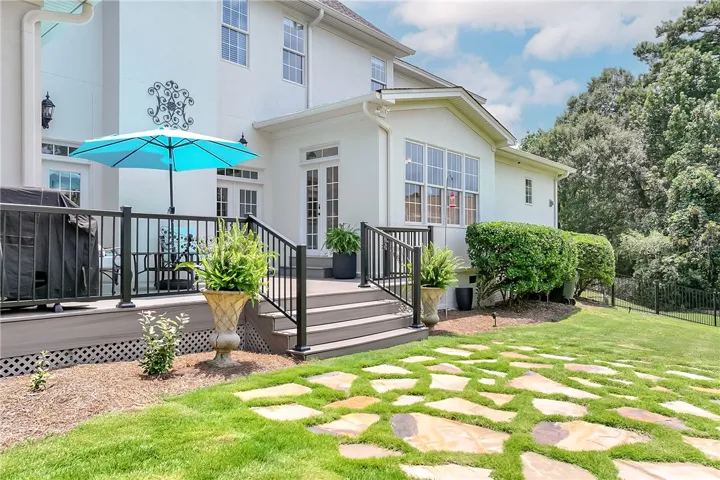 A graceful outdoor living space with a spacious deck and stepping stone path, perfect for al fresco enjoyment.