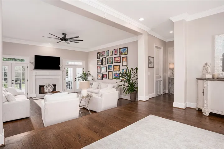 Hardwood floors and a pristine fireplace elevate this inviting gathering space.