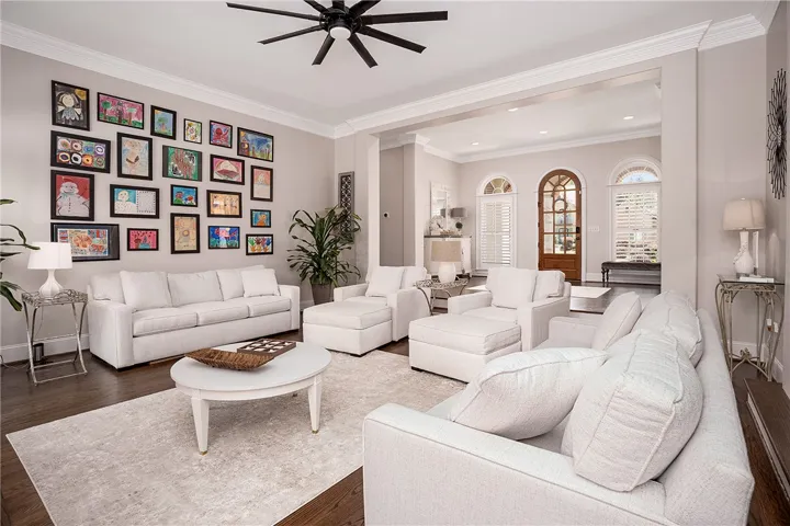Hardwood floors and generous crown molding define this elegant and spacious living area.