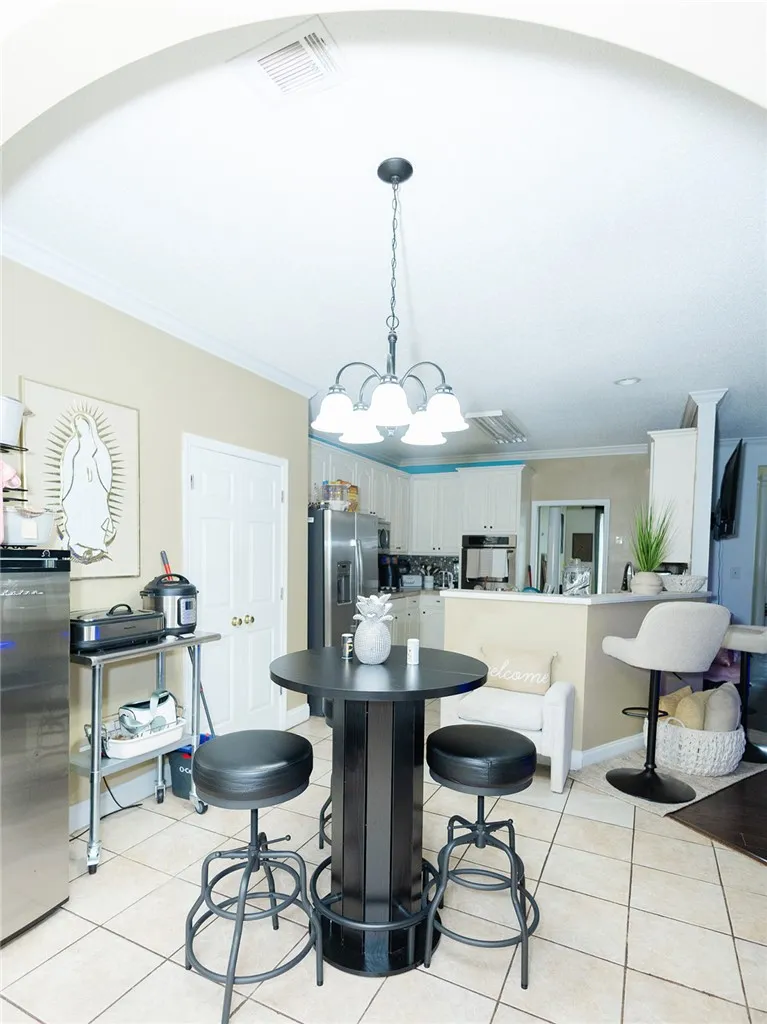 An inviting eat-in kitchen with a kitchen island and sleek stainless steel appliances awaits.