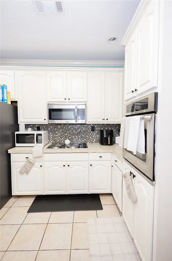 A well-appointed kitchen showcasing modern appliances and bright cabinetry.