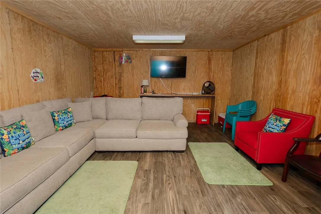 A comfortable lounging space with warm wood paneling and durable flooring.
