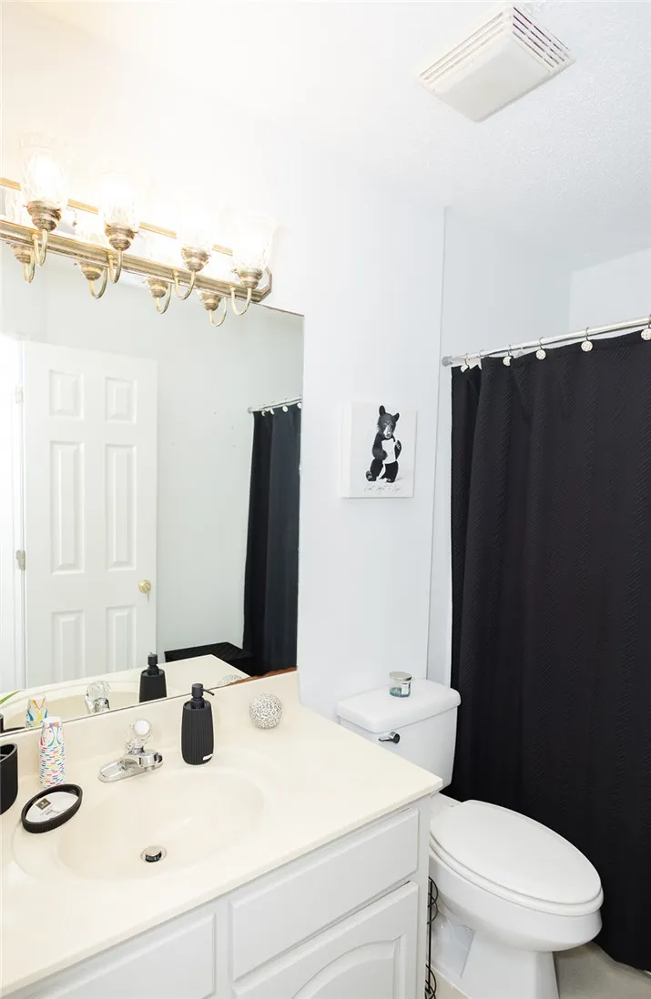 A well-appointed bathroom features a single vanity, ample mirror space, and a combination tub/shower.