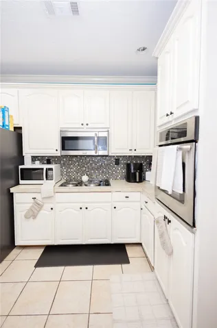 A well-appointed kitchen showcasing modern appliances and bright cabinetry.