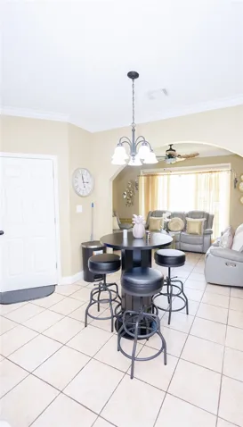 A well-lit casual dining area seamlessly transitions into a comfortable living space with an open floor plan.