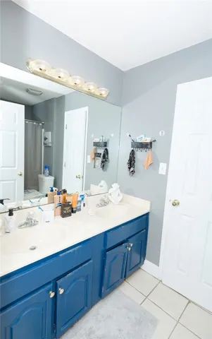 Double vanity with ample counter space and storage cabinetry, perfect for a busy household.
