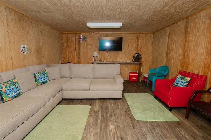 A comfortable lounging space with warm wood paneling and durable flooring.
