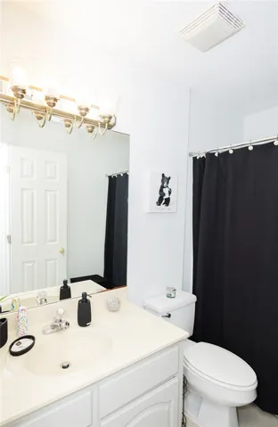 A well-appointed bathroom features a single vanity, ample mirror space, and a combination tub/shower.