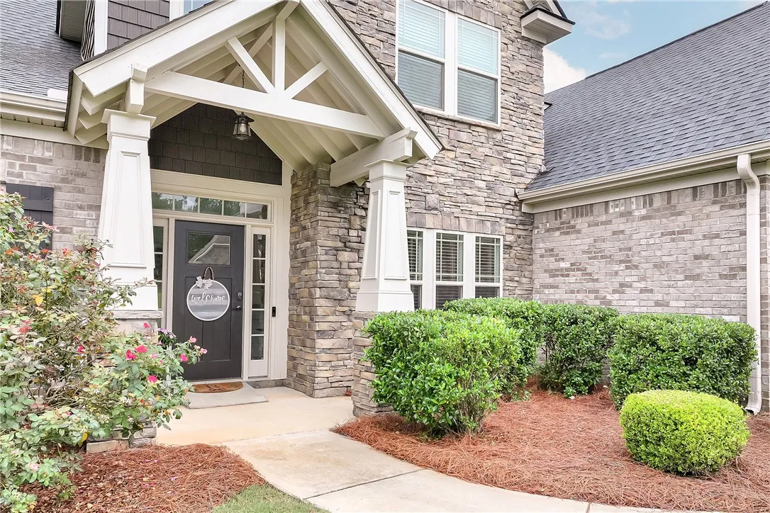 A graceful entry with decorative stone and brickwork provides charming curb appeal.