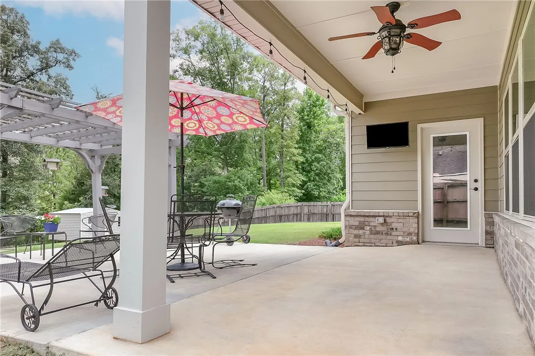 An inviting outdoor living space features a covered patio perfect for al fresco dining and relaxation.