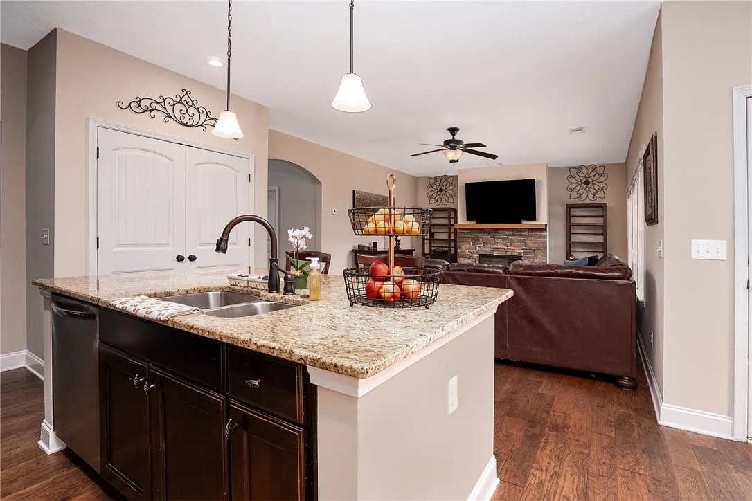 A functional kitchen island featuring a dual-basin sink, providing both utility and a clear sightline to the inviting living area.