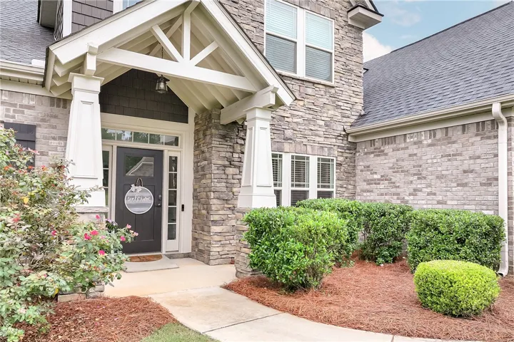 A graceful entry with decorative stone and brickwork provides charming curb appeal.