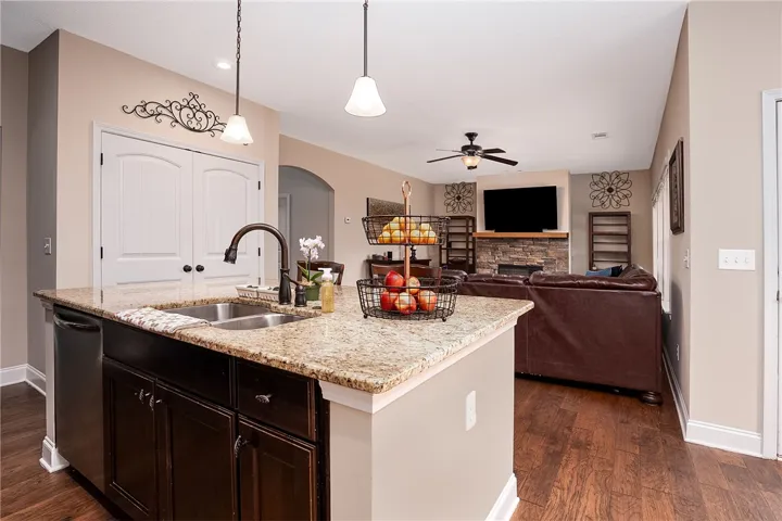 A functional kitchen island featuring a dual-basin sink, providing both utility and a clear sightline to the inviting living area.