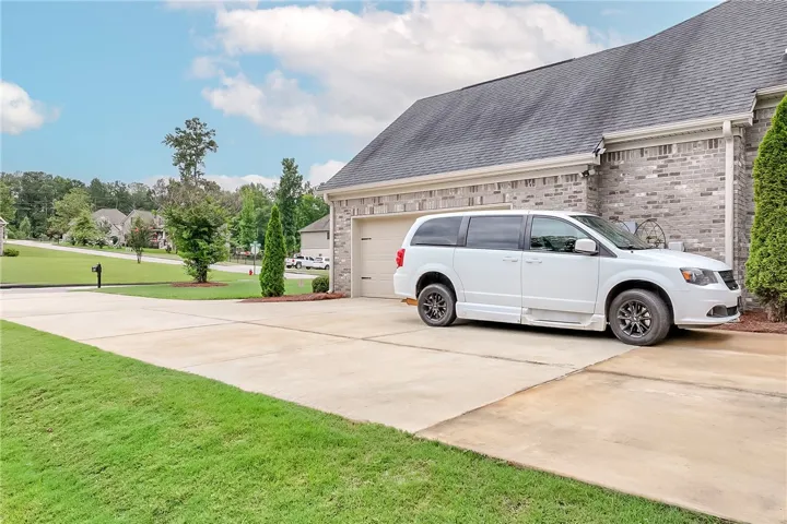 A well-maintained brick exterior and concrete driveway provide welcoming curb appeal.