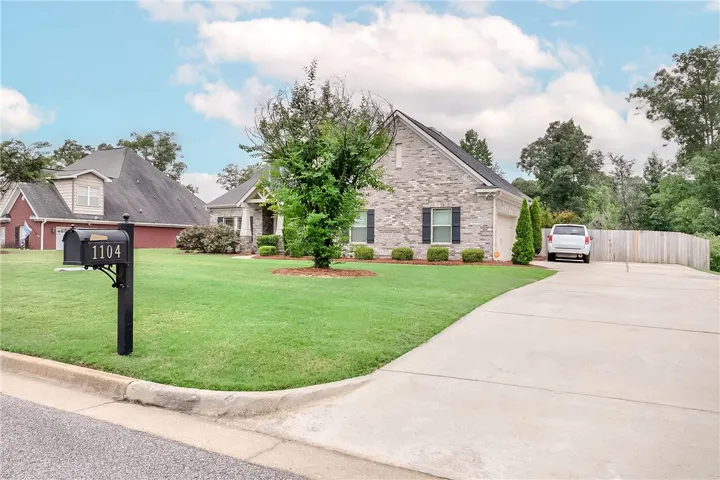A classic brick exterior with dark shutters welcomes you home to this suburban dwelling.