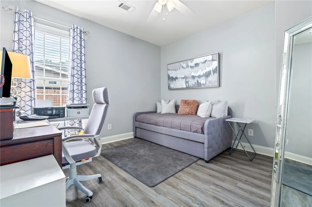 A well-lit, versatile room provides ample space for both work and leisure.