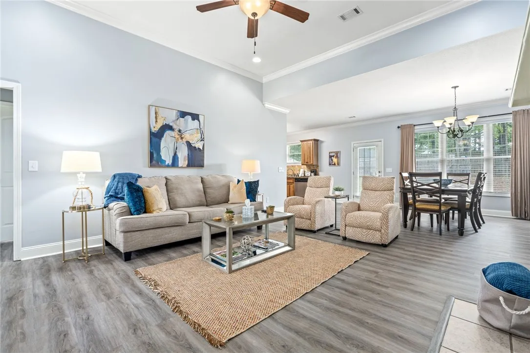 Step inside this inviting great room, seamlessly connecting living and dining areas with durable flooring.