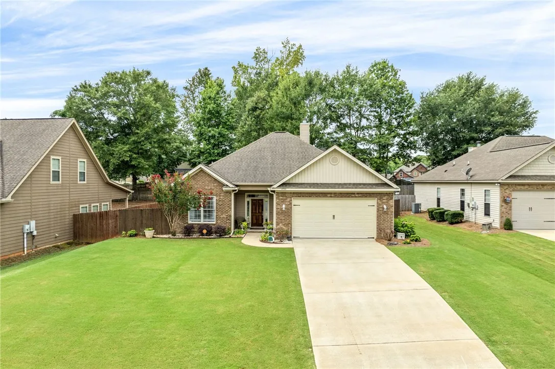 A classic brick exterior and welcoming entrance define this charming residence.