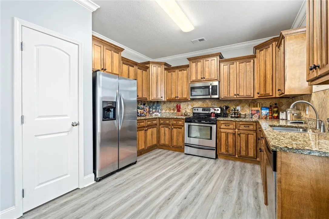 Well-appointed kitchen offering abundant storage, durable countertops, and sleek stainless steel appliances.