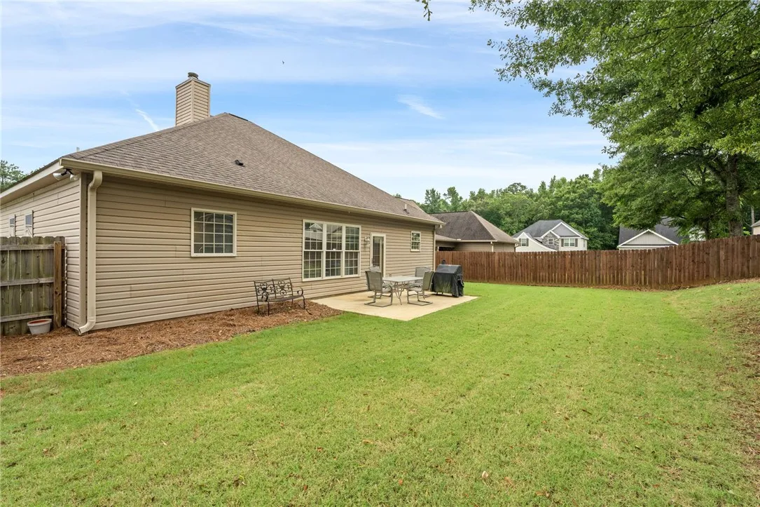 A well-maintained fenced backyard offers a private patio area perfect for outdoor enjoyment.