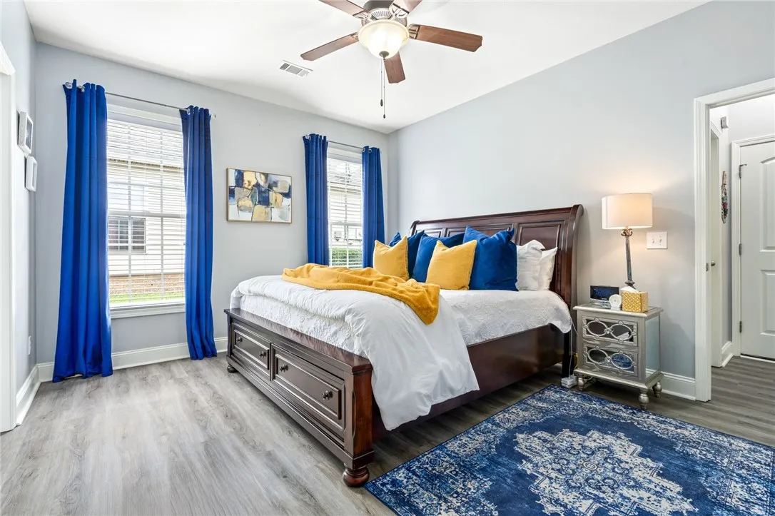 Hardwood floors and generous natural light create an inviting primary bedroom retreat.