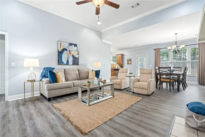 Step inside this inviting great room, seamlessly connecting living and dining areas with durable flooring.