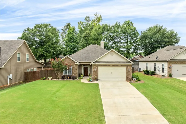 A classic brick exterior and welcoming entrance define this charming residence.
