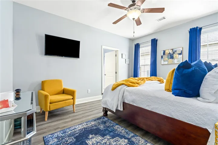 Relax in this tranquil sleeping area, complete with resilient wood-look flooring and a comforting ceiling fan.