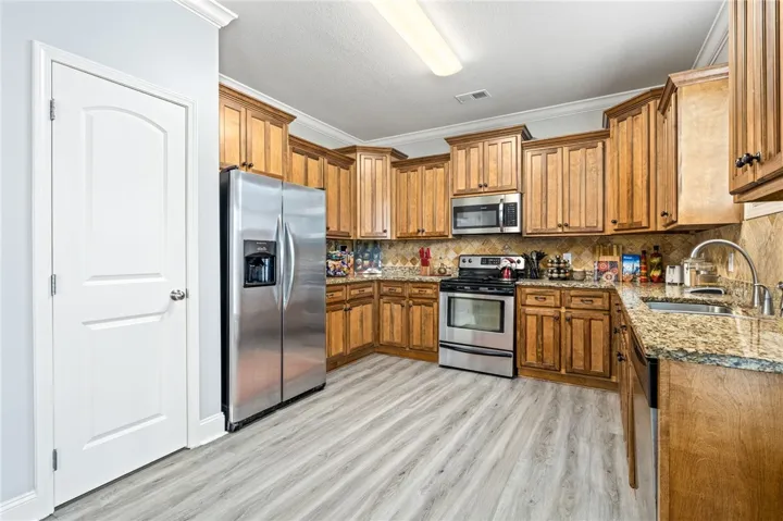 Well-appointed kitchen offering abundant storage, durable countertops, and sleek stainless steel appliances.
