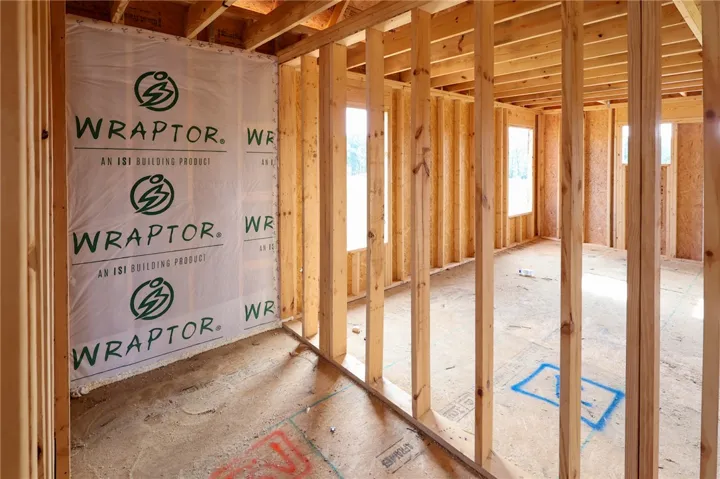 Sturdy wood framing defines the structural layout of this under-construction residential space.