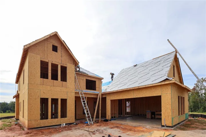 New residential construction in progress showcases a multi-level design with an integrated garage.