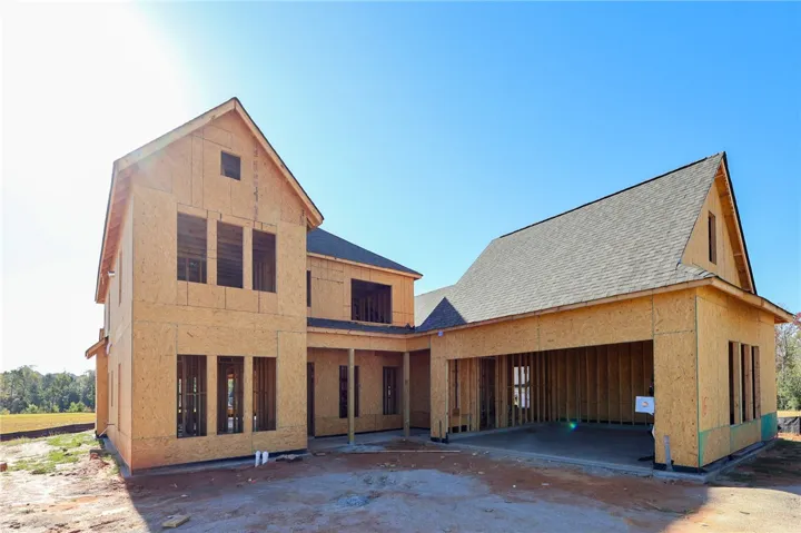 A new custom residence takes shape with classic gables and an attached three-car garage.