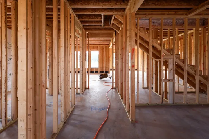 Exposed wood framing and subfloors show the promising layout of this custom home under construction.