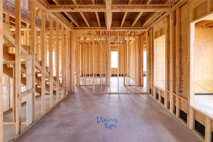 Exposed wood framing and concrete subfloors mark the early stages of this custom home.