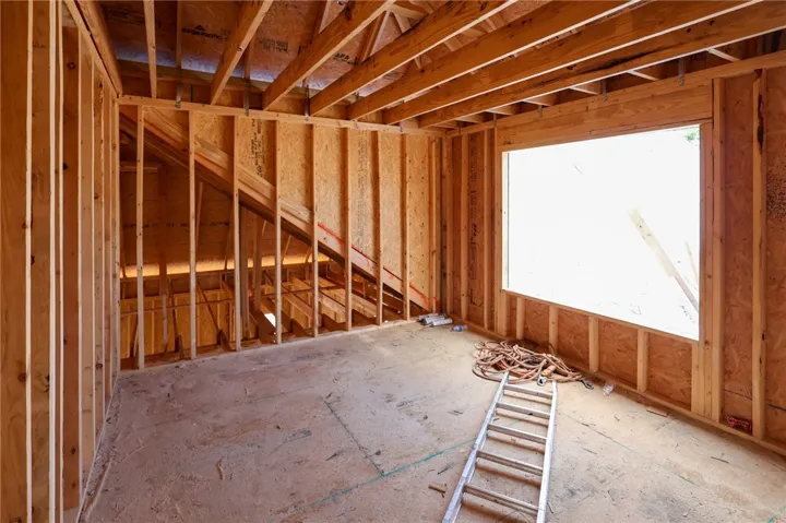 Exposed wood framing and subfloors outline a customizable upper-level space awaiting final finishes.