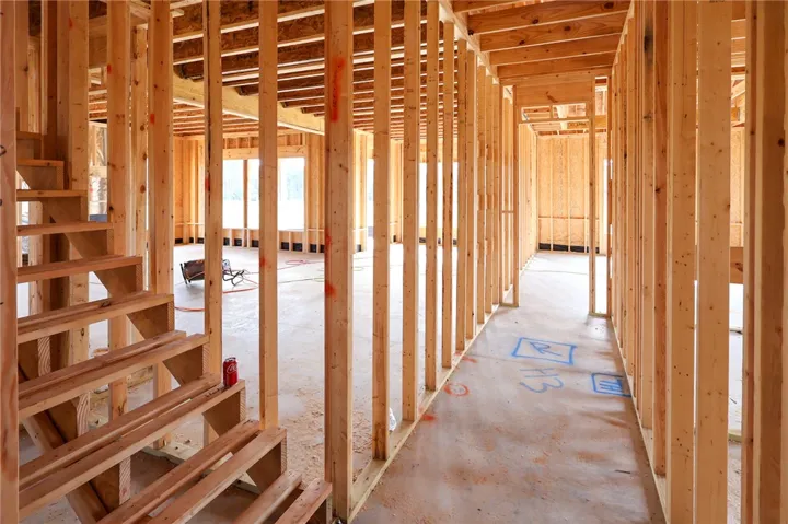Sturdy wood framing and an open layout define this custom home under construction.