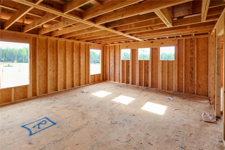 Exposed wood framing and subfloors highlight the open layout of this unfinished interior structure.