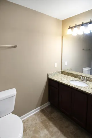 Granite counters and tile flooring highlight this well-appointed bathroom.